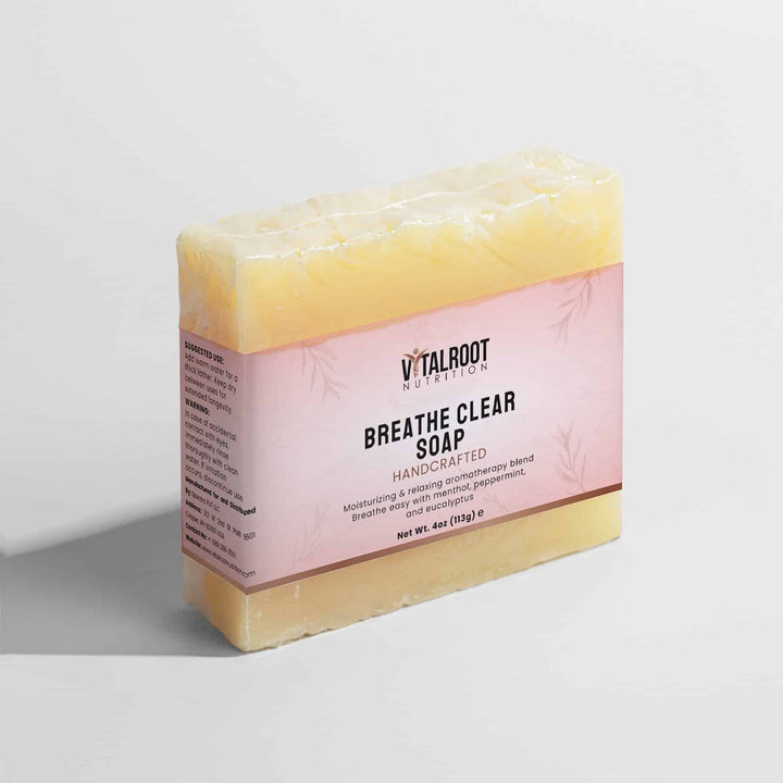 Bar of soap with a pink label on a light gray background