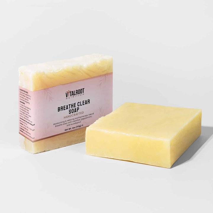 Bar of Breathe Clear Soap next to its packaging on a light gray background