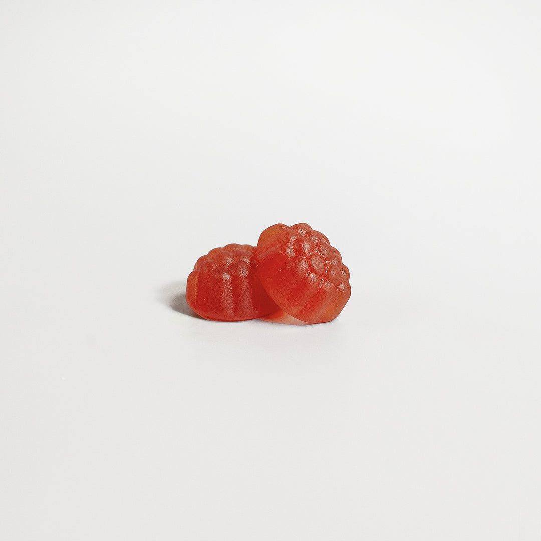 Two red gummy candies on a white background