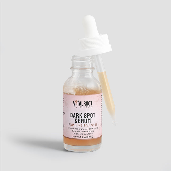 Vital Root Dark Spot Serum bottle with applicator on a light gray background