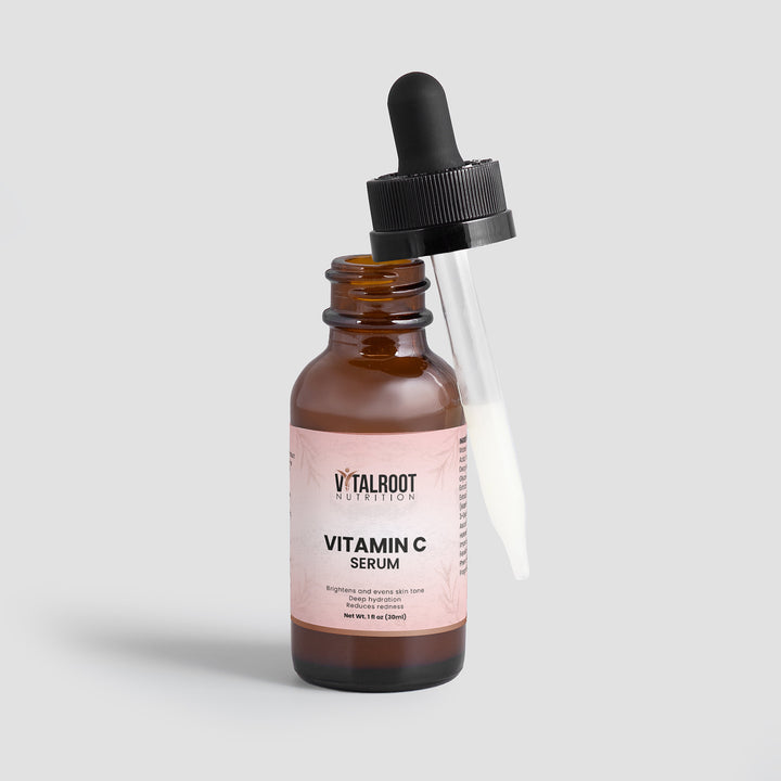 Vitamin C serum bottle with dropper on a light gray background