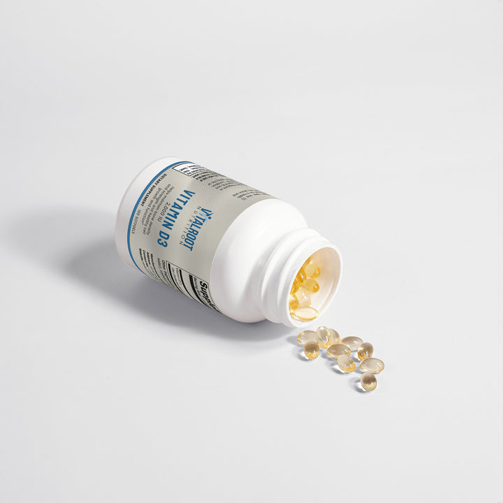 Vitamin supplement bottle with pills on a light gray background