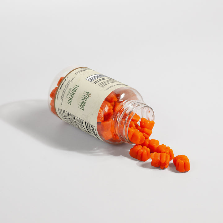 Open jar of orange gummy bears with a visible brand label on a white background