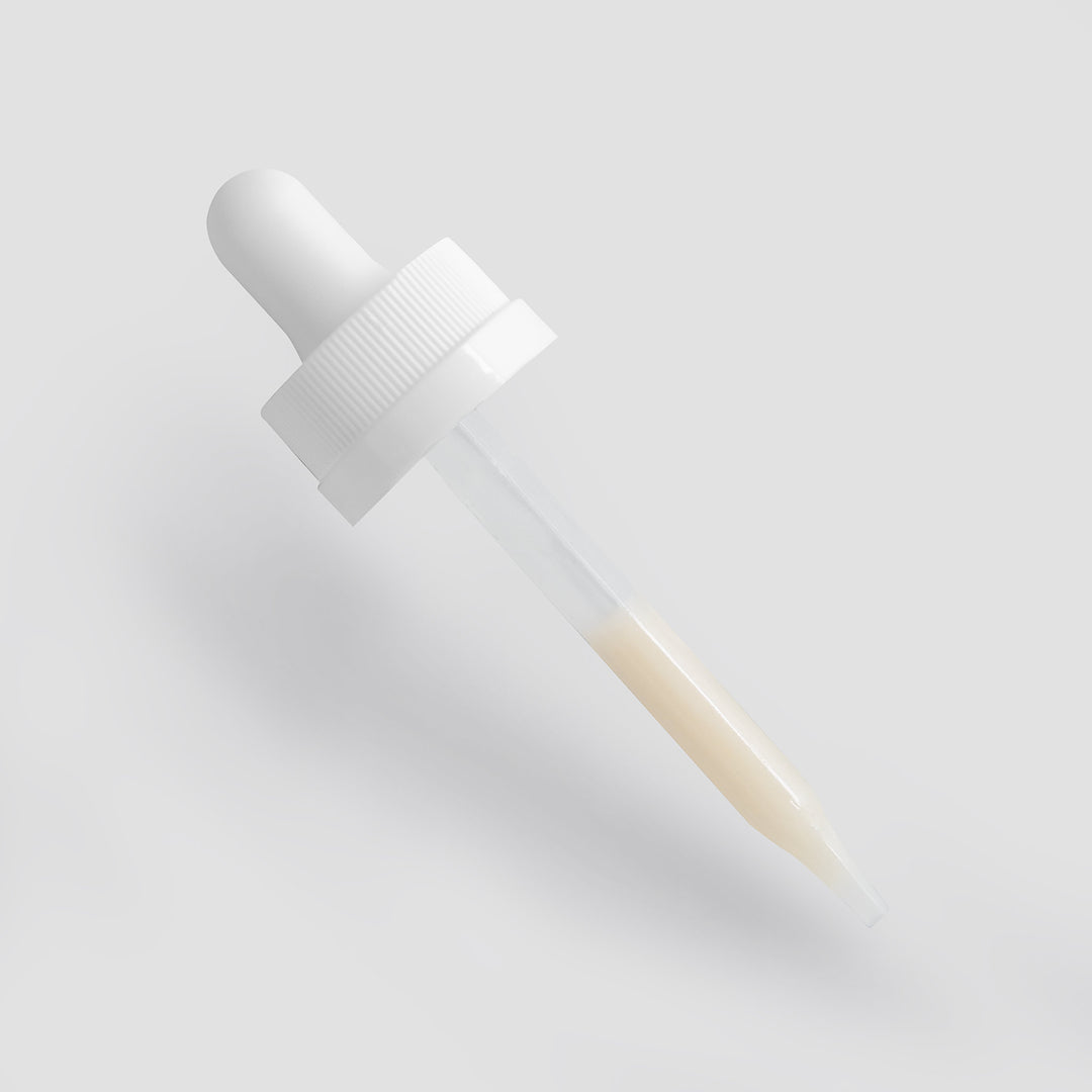 White dropper bottle on a light gray background