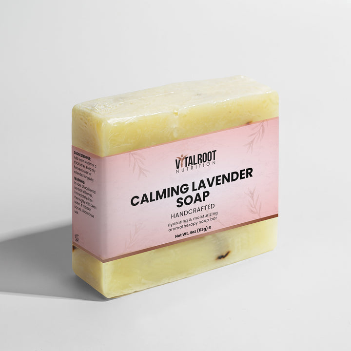 Bar of Calming Lavender Soap with a pink label on a light gray background