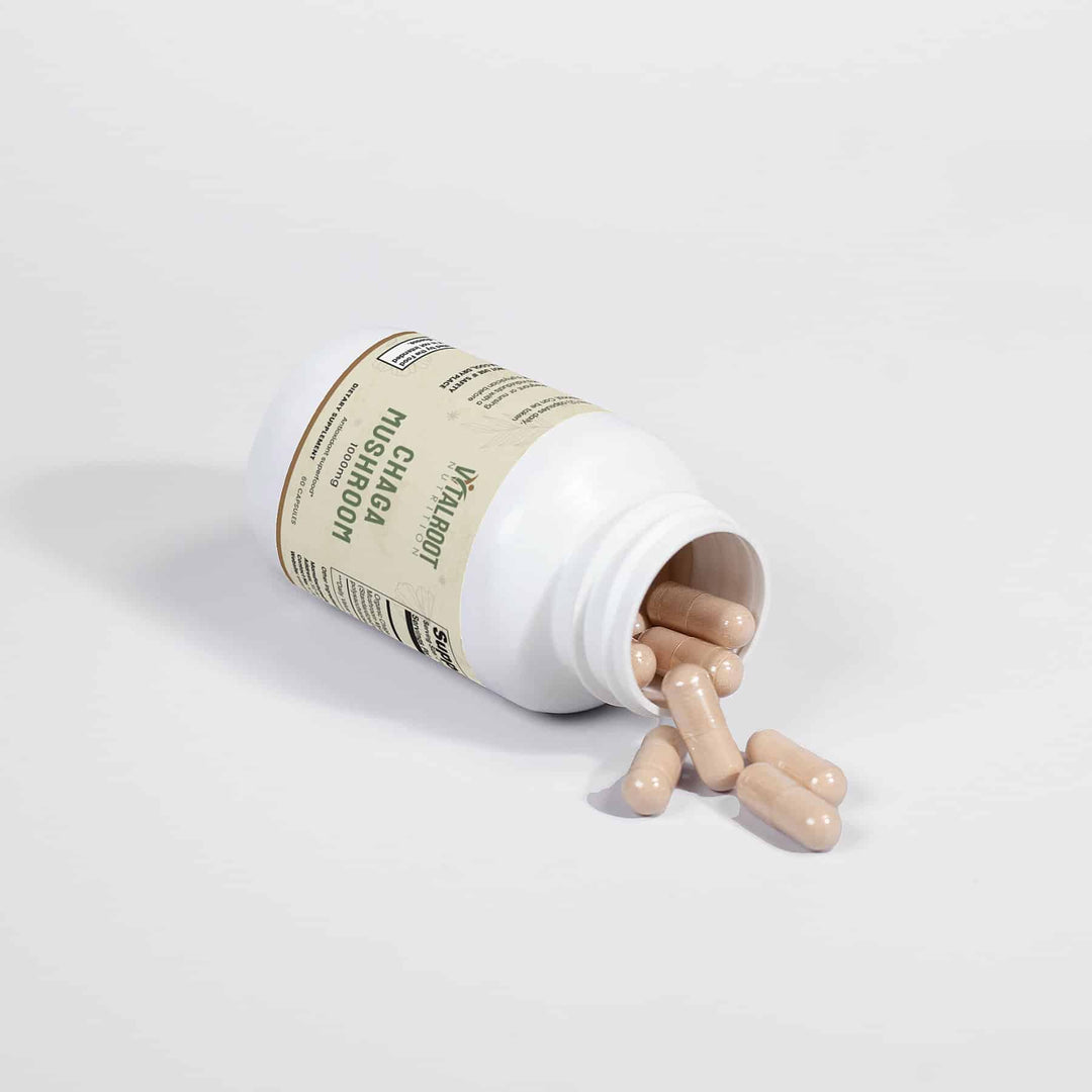 Open supplement bottle with pills spilling out on a light gray background