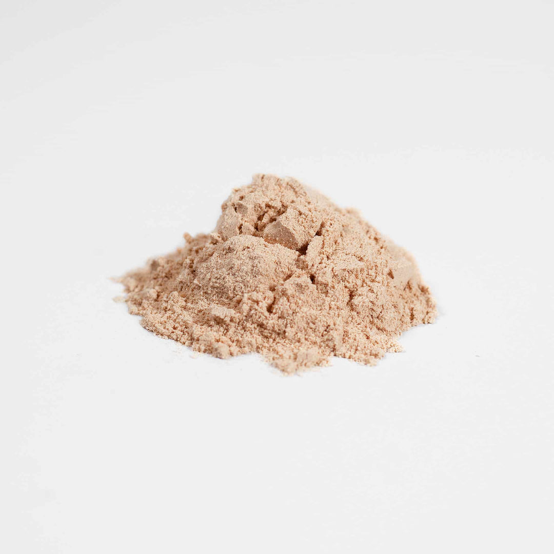 Two mounds of beige powder on a light gray background