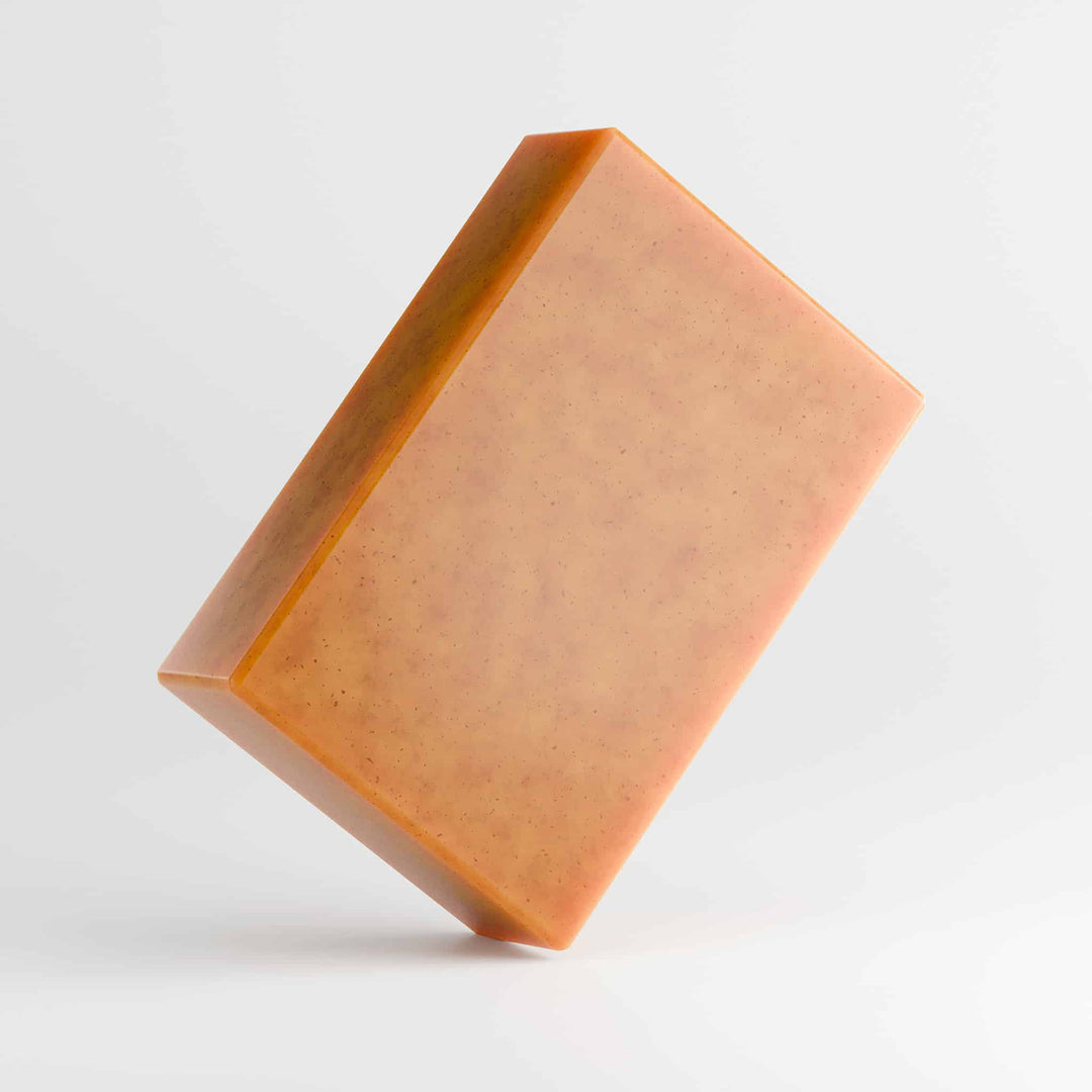 Orange soap bar on a white background