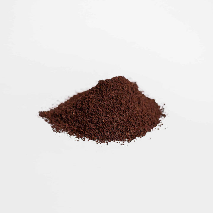 Pile of ground coffee on a white background