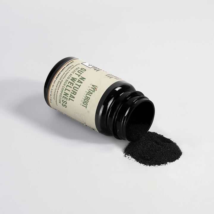 Black powder spilling out of a black container with a label on a light gray background