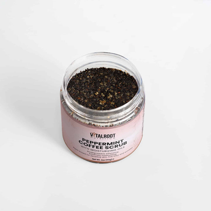 Jar of peppermint coffee scrub with visible label on a white background