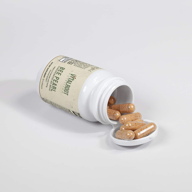 Bee Pearl bottle with capsules spilled out next to the bottle, showing the product.