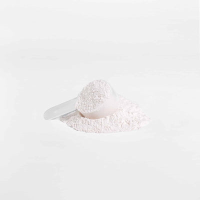 Close-up of VitalRoot BCAA Honeydew Watermelon powder in a scoop, emphasizing the powder texture and serving amount.