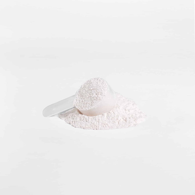 Close-up of VitalRoot BCAA Honeydew Watermelon powder in a scoop, emphasizing the powder texture and serving amount.
